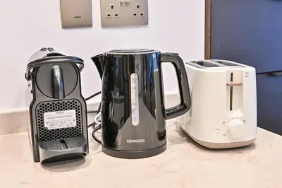 two appliances sitting on a counter next to a toaster at Stunning 1Bdr Luxury with Burj Khalifa View in Dubai