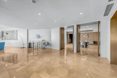 a living room with a wooden floor and a dining room at luxury penthouses see view at five in Dubai