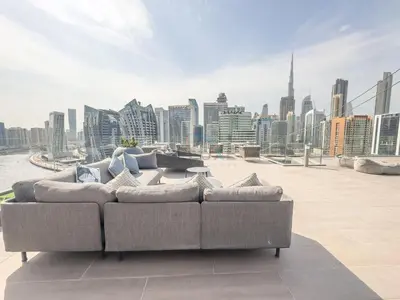 a couch sitting on top of a building with a city skyline at Elegant Studio Next to Dubai Water Canal, 15 Northside Tower 1, Business Bay by Deluxe Holiday Homes in Dubai