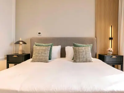 a bedroom with a large white bed with pillows at Fresh 3BR Apartment in 5-star Resort in Dubai
