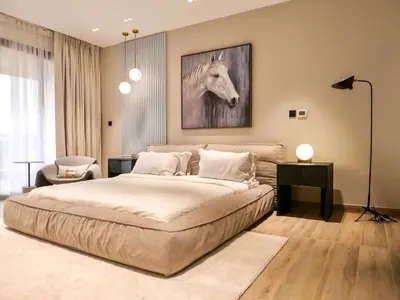 a bedroom with a bed with a horse painting on the wall at Fresh 3BR Apartment in 5-star Resort in Dubai