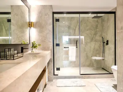 a bathroom with a walk in shower and a sink at Fresh 3BR Apartment in 5-star Resort in Dubai