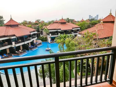 a view from a balcony of a resort with a pool at Fresh 3BR Apartment in 5-star Resort in Dubai