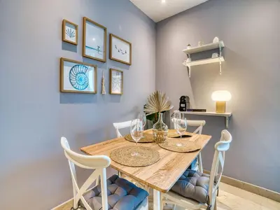a dining room with a wooden table and chairs at Classic Orra Marina-1BR in Dubai
