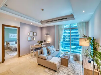 a living room with a couch and a table at Classic Orra Marina-1BR in Dubai