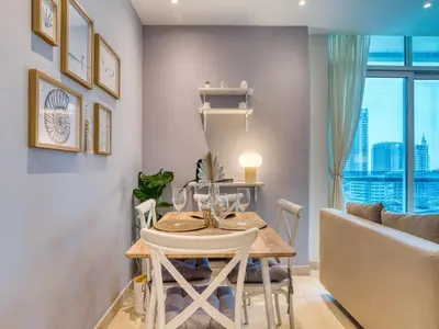 a dining room with a table and a couch at Classic Orra Marina-1BR in Dubai
