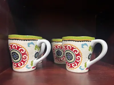 two coffee mugs sitting on top of a table at Dubai mall Aparment in Dubai