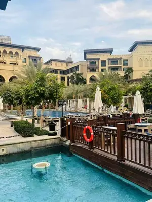 a swimming pool with a red life preserver in a resort at Dubai mall Aparment in Dubai