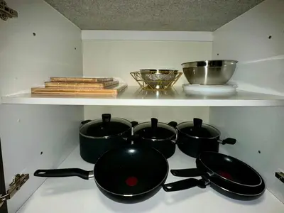 a group of pots and pans on a stove at Cozy Family-Friendly 2BR in JVT in Dubai
