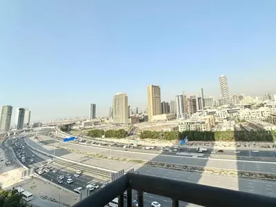 a highway in a city with cars on it at Cozy Family-Friendly 2BR in JVT in Dubai