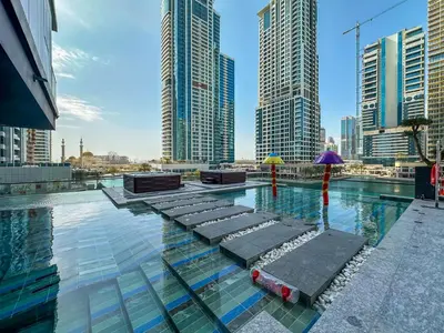 a pool in the middle of a city with tall buildings at MBL Royal, JLT -One Bedroom with Lake View in Dubai