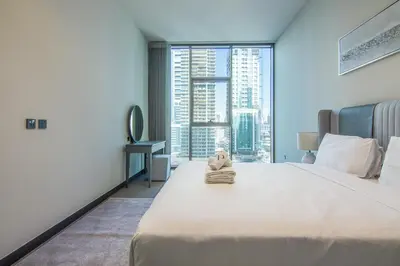 a bedroom with a large bed with a stuffed animal on it at MBL Royal, JLT -One Bedroom with Lake View in Dubai