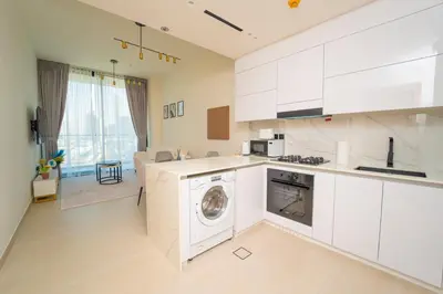a kitchen with a washer and a washing machine at AWS Holiday Homes - Perfect Dubai Stay! in Dubai