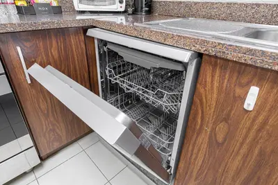 an empty dishwasher in a kitchen next to a sink at 3BR plus Maid Executive Tower L, City View in Dubai