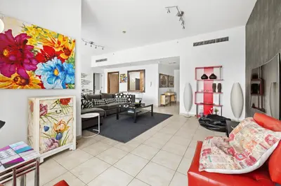 a living room filled with furniture and a painting on the wall at 3BR plus Maid Executive Tower L, City View in Dubai