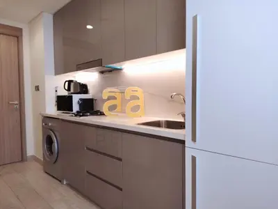 a kitchen with a sink and a washer and dryer at Pet Free Studio Apartment Close Downtown Fast Wi-fi in Dubai