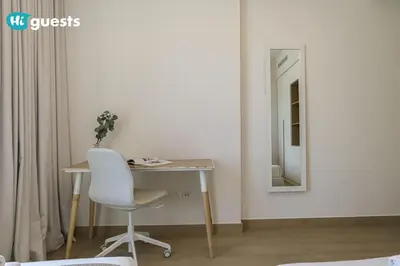 a white desk with a chair and a mirror at HiGuest - Coastal Luxury 2BR in La Mer Beachside Bliss in Dubai