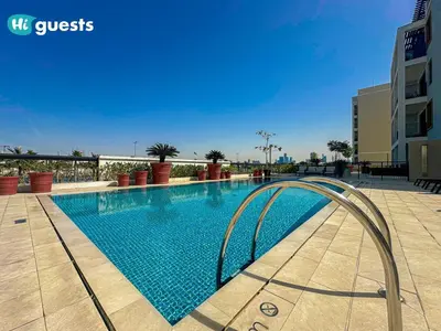 a swimming pool in a building with a clear blue at HiGuest - Coastal Luxury 2BR in La Mer Beachside Bliss in Dubai
