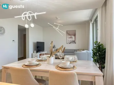 a dining room with a table with chairs and a dining room at HiGuest - Coastal Luxury 2BR in La Mer Beachside Bliss in Dubai