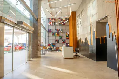 a lobby of a building with a wall of glass at Bnbeyond's Sheek Studio at Studio One tower in Dubai