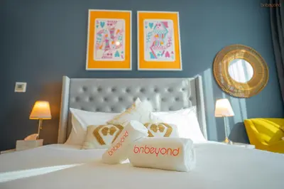 a hotel room with a bed with two packages of food at Bnbeyond's Sheek Studio at Studio One tower in Dubai