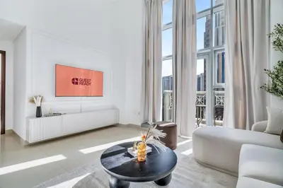 a living room with a couch and a table at GuestReady - Luxe 1BD Near Dubai Mall | 29 Blvd in Dubai