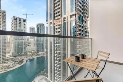a balcony with a table and a view of the city at GuestReady - Stylish haven with lake views in Dubai