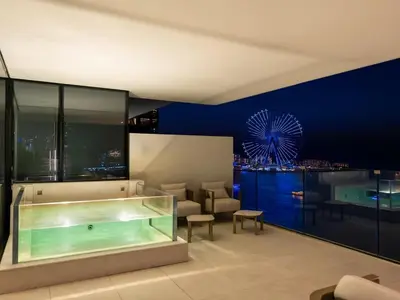 a hotel room with a swimming pool and a large aquarium at 1BR Suite FIVE LUXE - Pool & Beach view - Private Hot Tub - Ventura Stays in Dubai