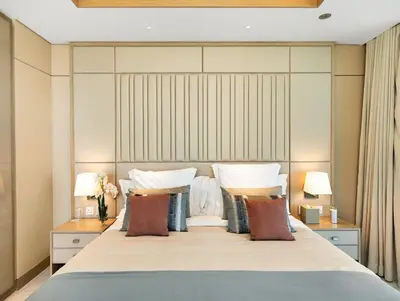 a bedroom with a large bed with pillows at 1BR Suite FIVE LUXE - Pool & Beach view - Private Hot Tub - Ventura Stays in Dubai