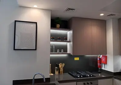 a kitchen with a sink and a counter top at Bespoke Holiday Homes - Luxury 1BR in High Floor with Stunning Canal Views in Dubai