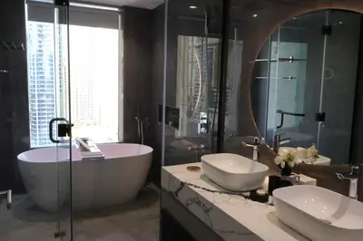 a bathroom with two sinks and a tub and a mirror at JW Marriott Stylish 1BR - Marina View - Direct Dubai Marina Mall Access - Pool & Gym - Free Parking in Dubai
