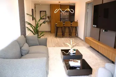 a living room with a couch and a table at JW Marriott Stylish 1BR - Marina View - Direct Dubai Marina Mall Access - Pool & Gym - Free Parking in Dubai