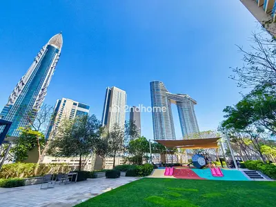 a park in a city with tall buildings at Burj Vista Tower 2, Downtown - Upgarded 2 bedroom in Dubai