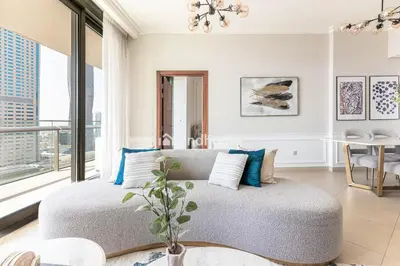 a living room with a couch and a large window at Burj Vista Tower 2, Downtown - Upgarded 2 bedroom in Dubai