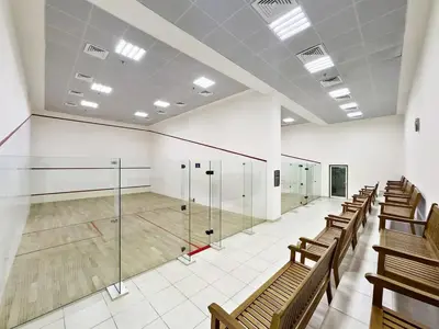 a gym with a tennis court in a building at GuestReady - Glamorous stay in Dubai Marina in Dubai
