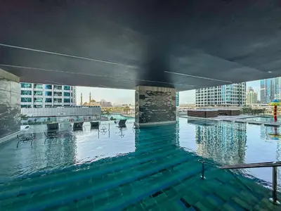 a swimming pool on top of a building at MBL Royal, JLT- 1-BR Apartment with Lake View in Dubai