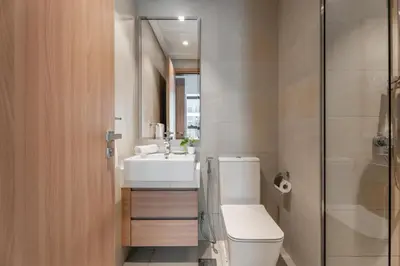 a bathroom with a toilet and a sink and a shower at GuestReady - Contemporary retreat at Azizi Gardens in Dubai