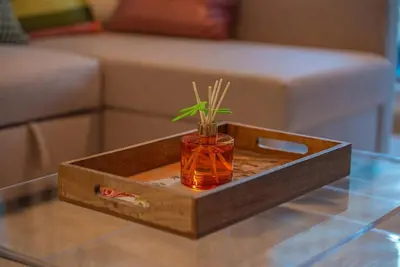 a wooden tray with a vase on a table at Luxury Living Brand New 1 Bed Downtown Dubai Southridge in Dubai