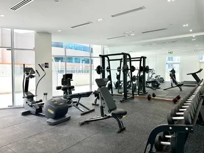 a gym with treadmills and cardio equipment in a building at Millenium Binghatti Residences Business Bay- Stylish Studio with Canal View in Dubai