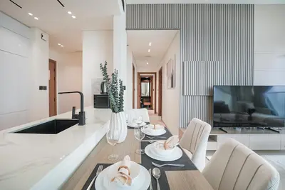 a kitchen and dining room with a table and chairs at EasyGo- Luxury, Private Pool and Serene Location in Dubai