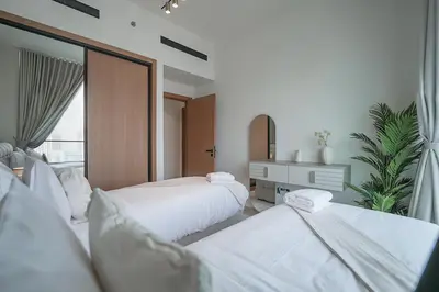 a hotel room with two beds and a mirror at EasyGo- Luxury, Private Pool and Serene Location in Dubai