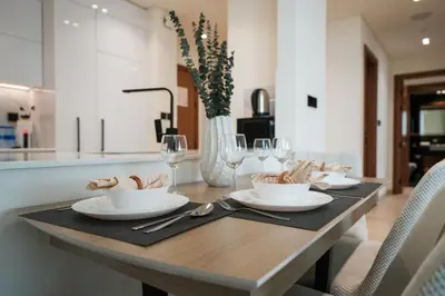 a wooden table with plates and bowls on it at EasyGo- Luxury, Private Pool and Serene Location in Dubai
