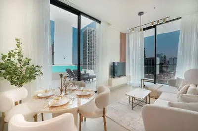 a living room with white furniture and large windows at EasyGo- Luxury, Private Pool and Serene Location in Dubai