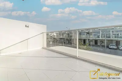 a view of a white building with glass windows at Tranquil 3br Townhouse in Damac Hills2 by deleguest in Dubai