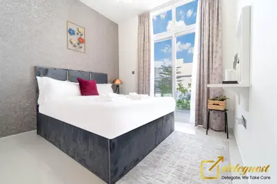 a large bed in a room with a large window at Tranquil 3br Townhouse in Damac Hills2 by deleguest in Dubai
