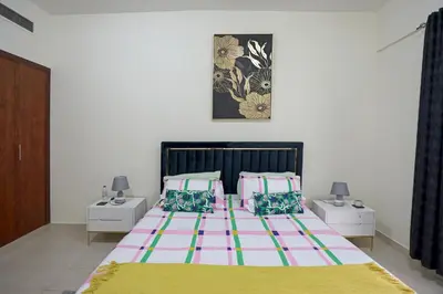 a bedroom with a large bed and two night stands at LUXURY 1BED MARINA VIEW JBR BEACH POoL PARKING in Dubai