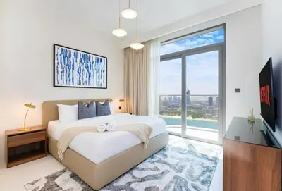 a bedroom with a large bed and a large window at شقة مع منظر رائع in Dubai