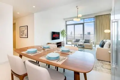a dining room table and chairs in a living room at شقة مع منظر رائع in Dubai