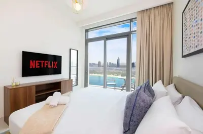 a bedroom with a bed with a tv and a window at شقة مع منظر رائع in Dubai