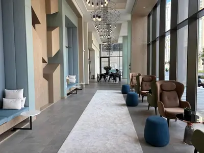 a lobby with a waiting room with chairs and tables at Sky Burj Khalifa View in Dubai